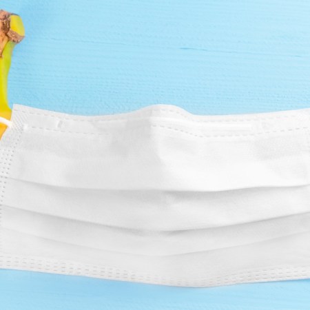 A surgical mask covers a banana