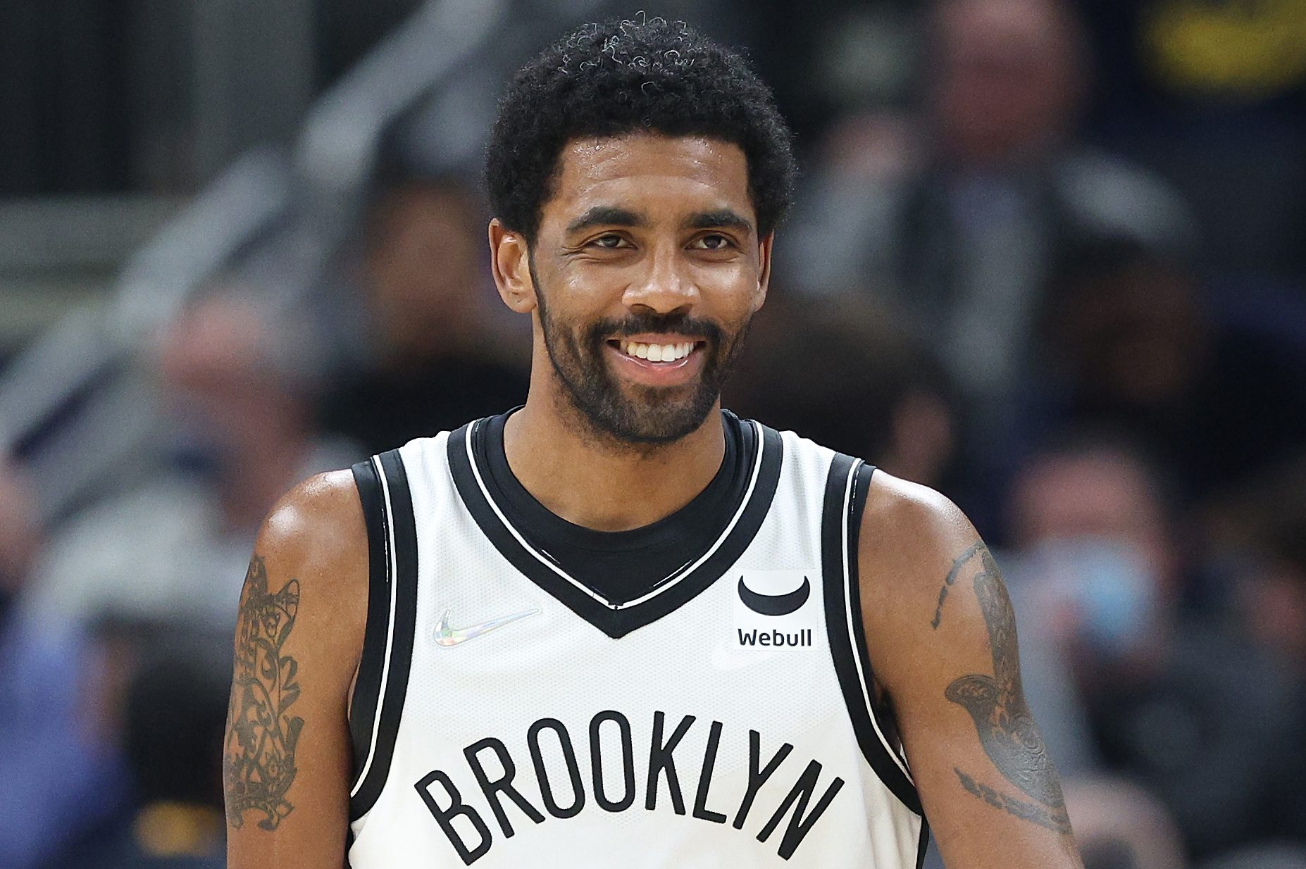 Kyrie Irving dribbles the ball during a 2022 game against the Pacers. The unvaccinated NBA star could technically play in Brooklyn if the Nets pay a fine.