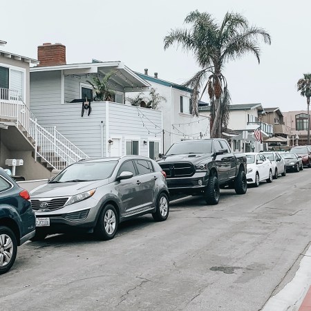 A row of cars, trucks and SUVs parked on a street in California