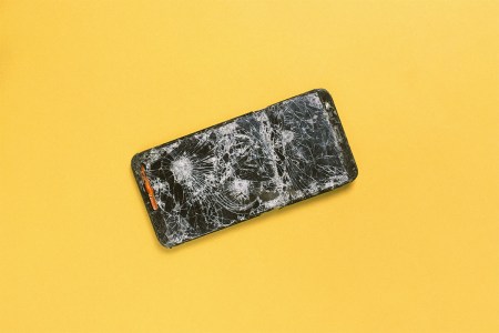 A photo of a cracked phone against a yellow background. Here's what it was like when I went on a 72-hour digital detox from my phone.