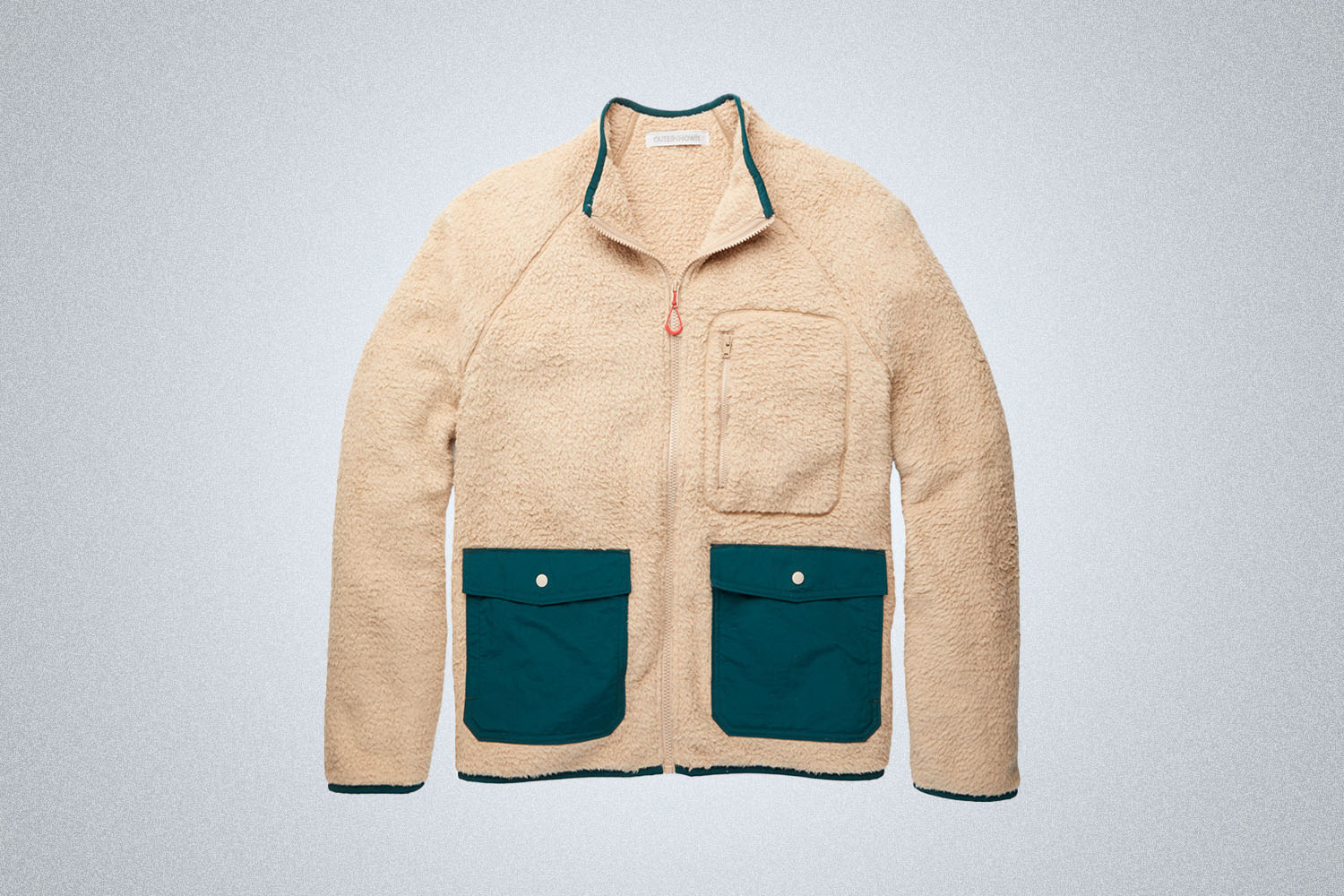 a cream fleece with green pockets