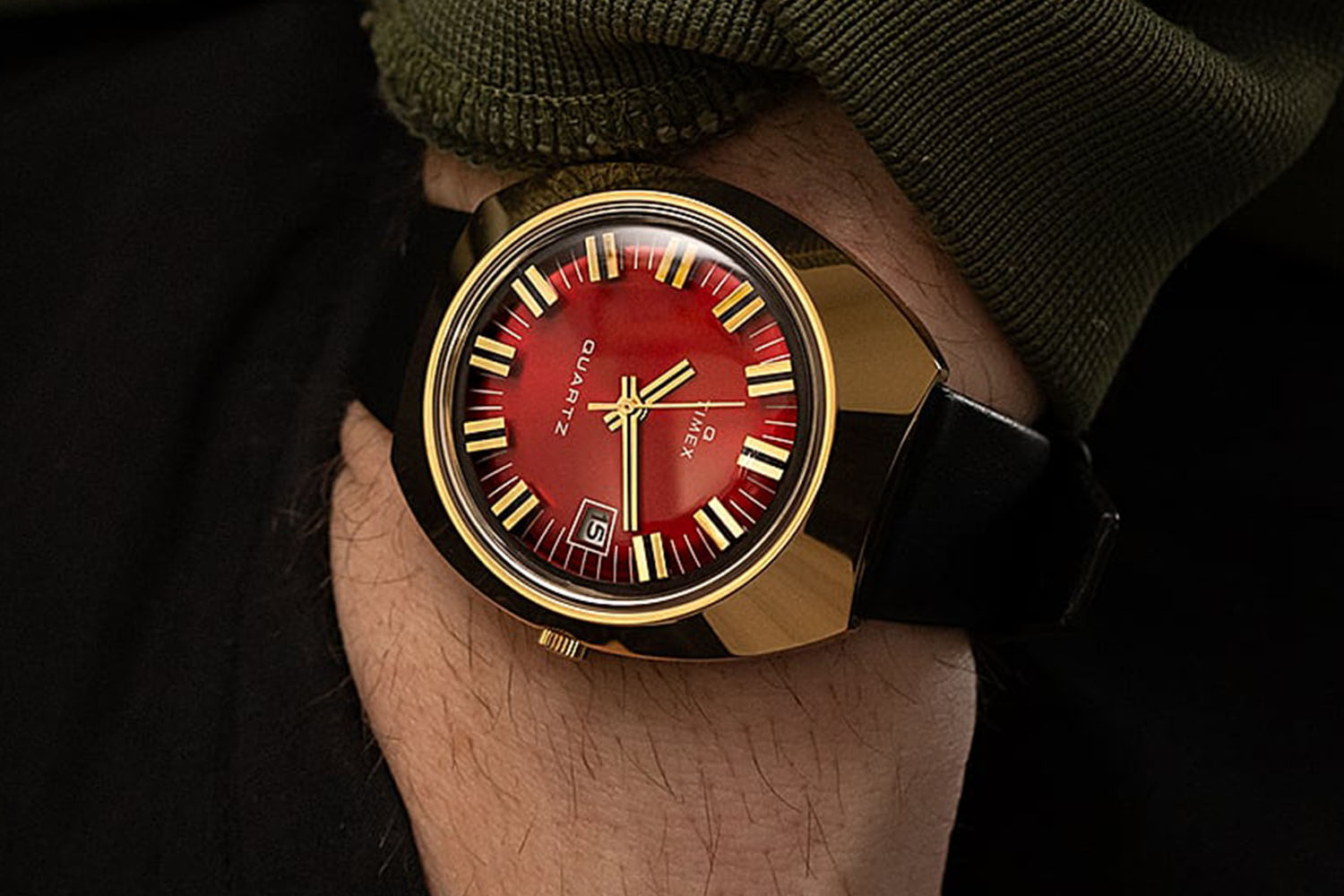 a rose gold watch with a gold rim and leather strap