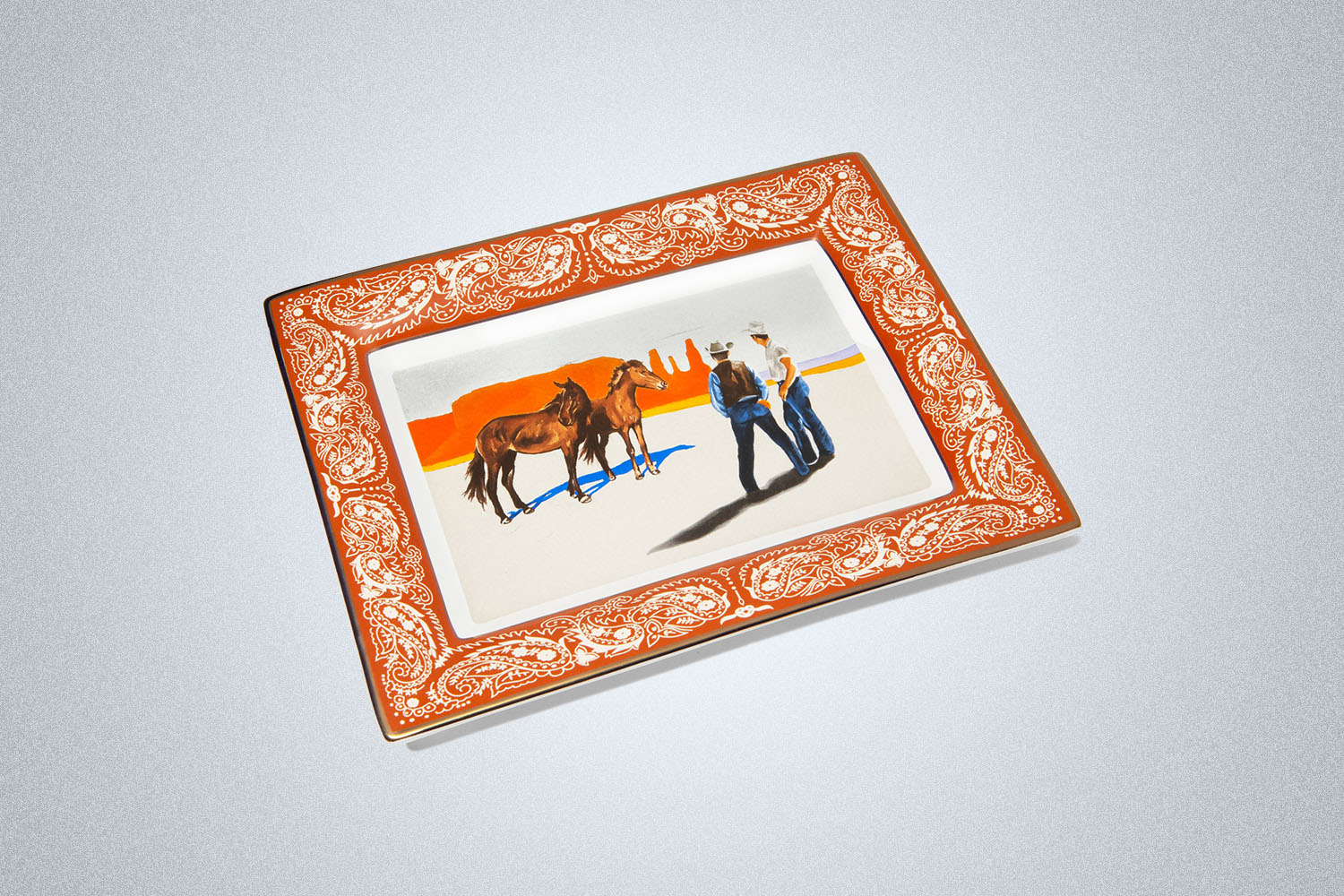 an ashtray with a western image printed on it
