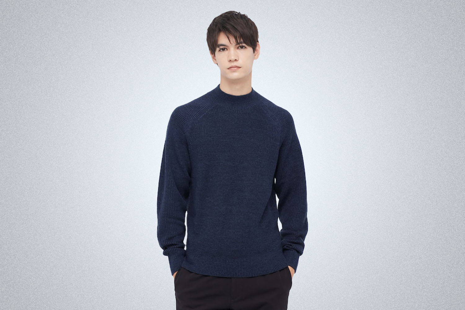 a model in a blue Uniqlo sweater