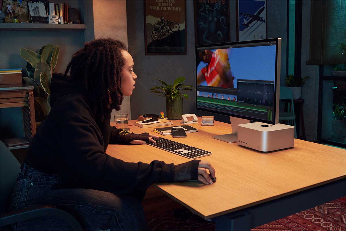 A person working with the new Mac Studio and Studio Display