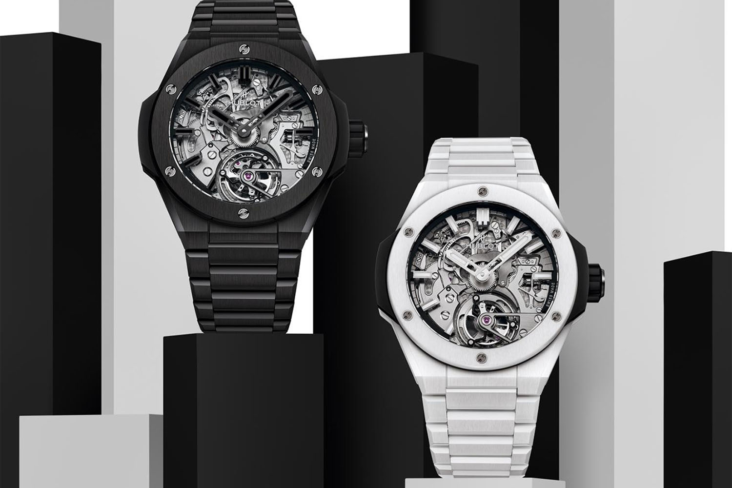 Two Hublot Watches on a black, grey, and white background