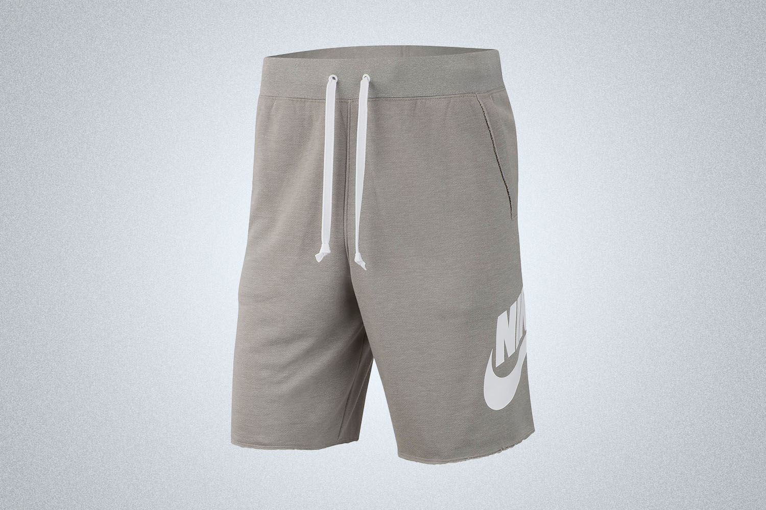 A pair of grey sweatshorts with Nike branding on a grey background