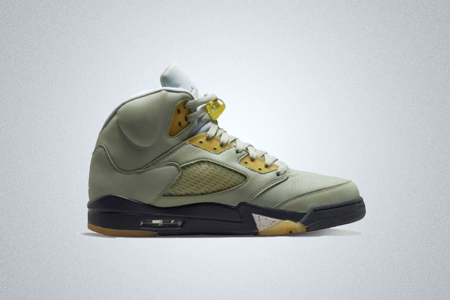 A jade green Nike Jordan 5 on a grey background