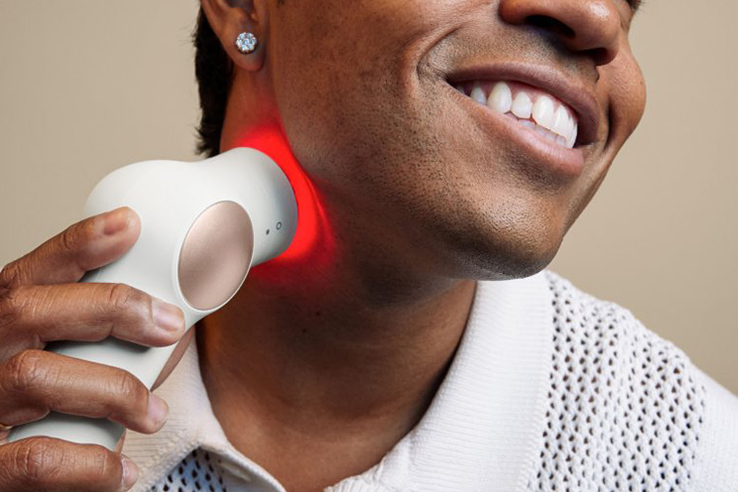A therabod device a model is using on their neck