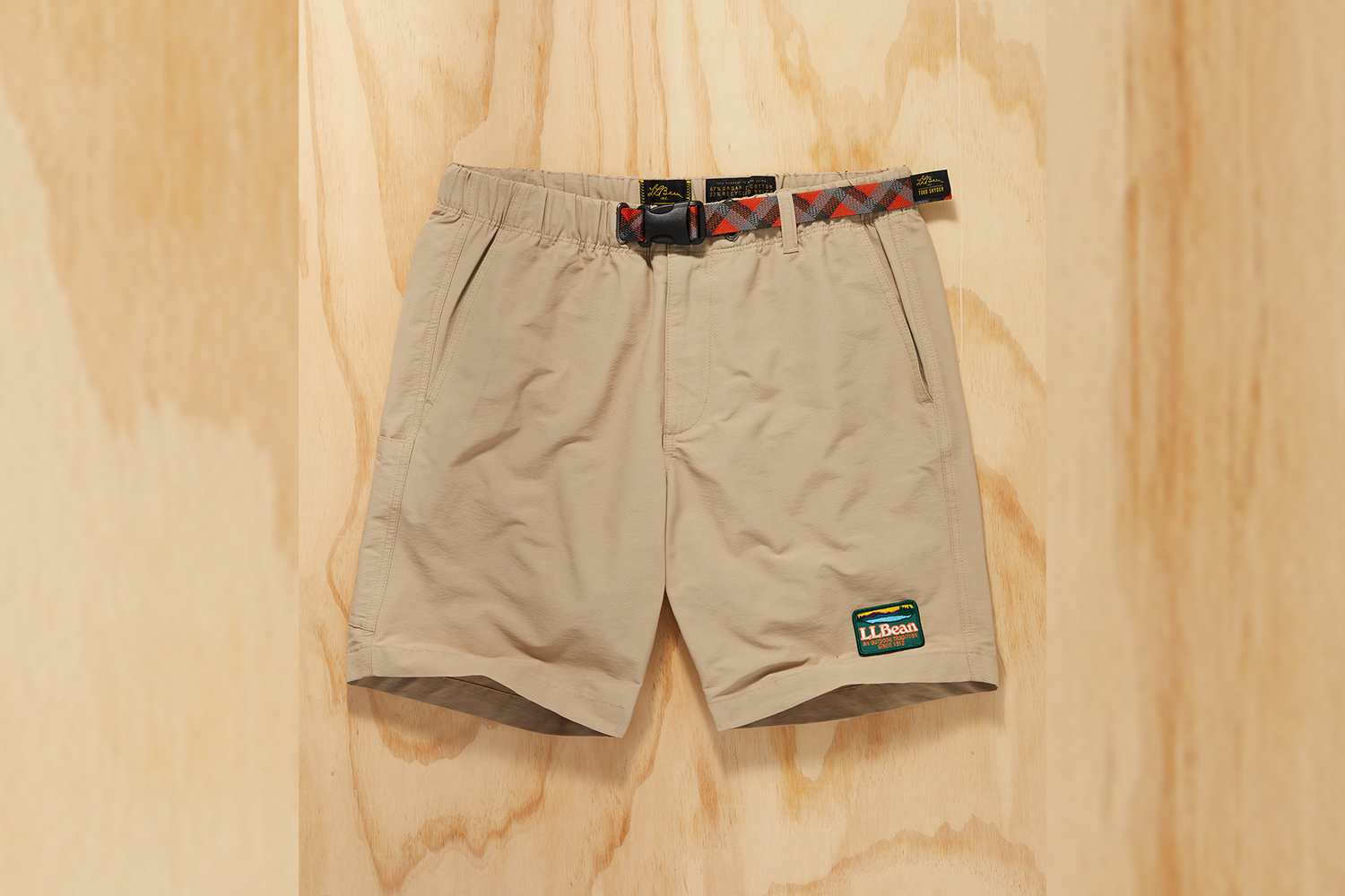 a pair of tan hiking shorts on a wood background