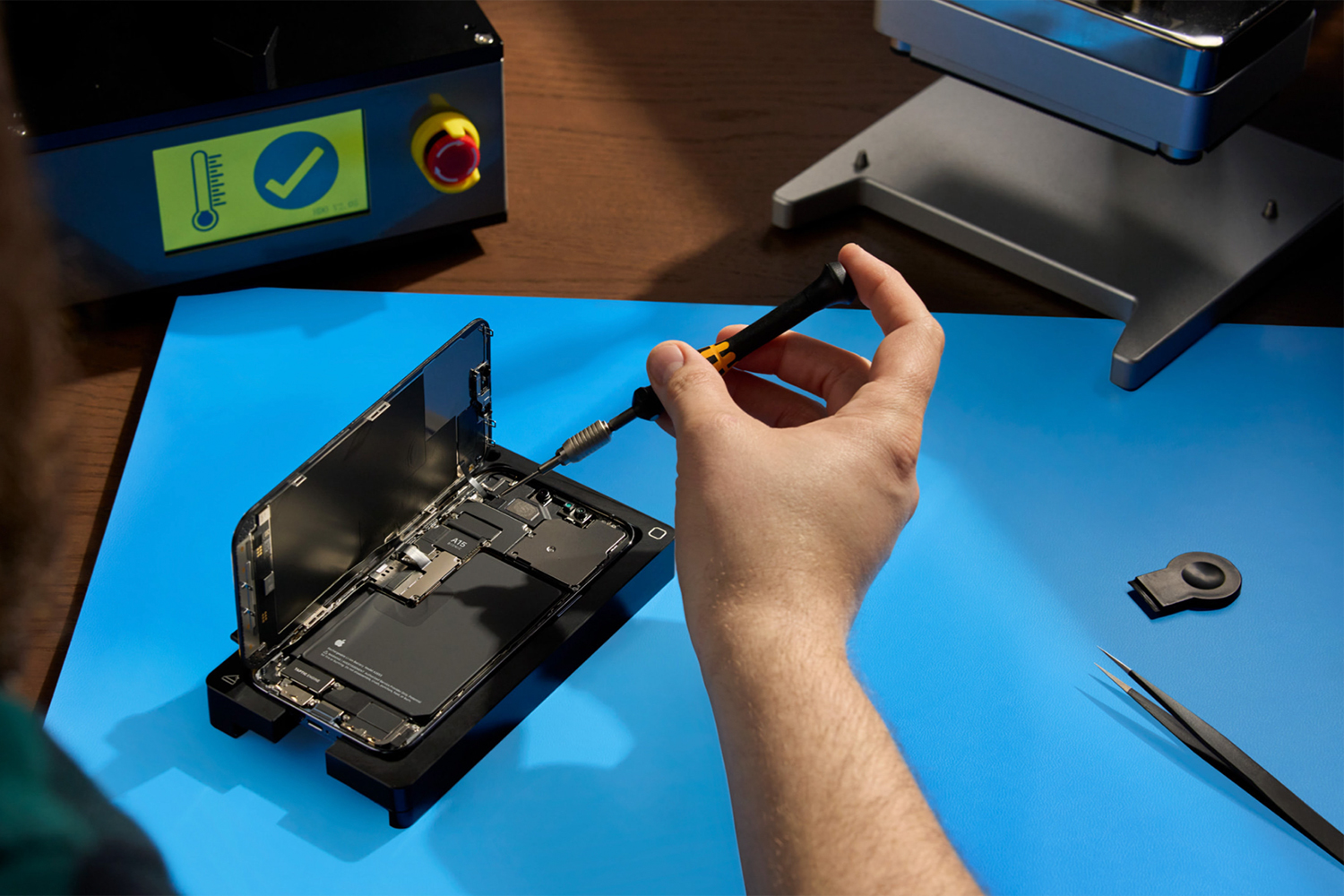 a hand fixing an iPhone