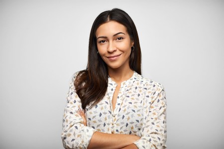 A brunette woman in business attire looking at camera.