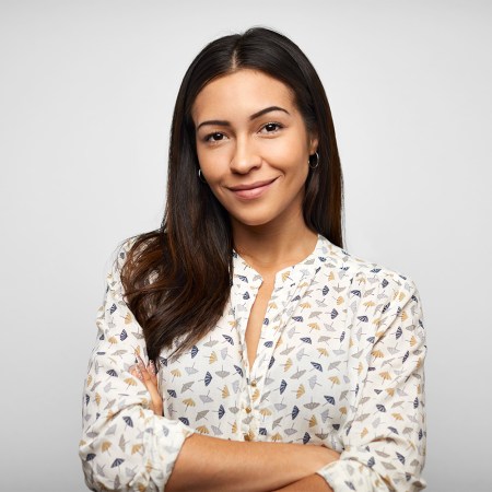 A brunette woman in business attire looking at camera.