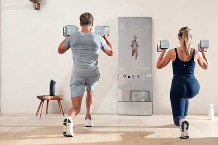 A woman and man working out with the Mirror, a home fitness device embedded in a reflective mirror. We take a look at why the home gym is the perfect Mother's Day gift for 2022.