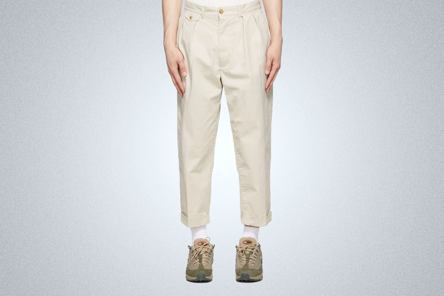 a model in beige Beams Plus pants on a grey background