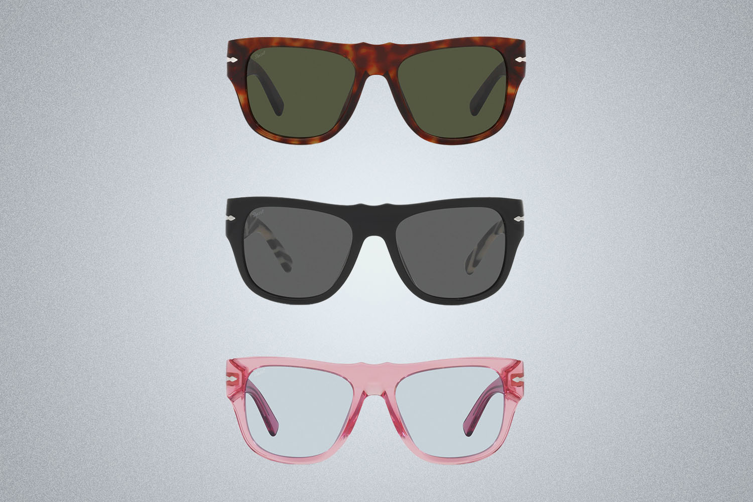 A trio of sunglasses in different colors from Dolce&Gabbana x Persol on a grey background