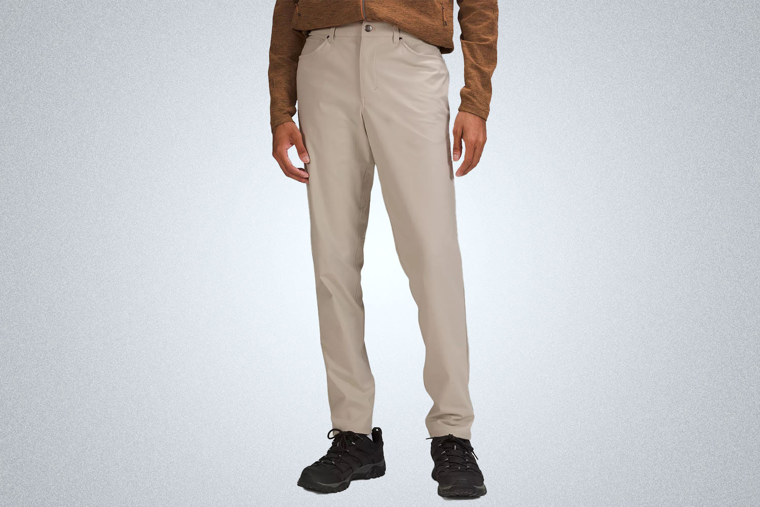 a model wearing a pair of lululemon ABC pants on a grey background