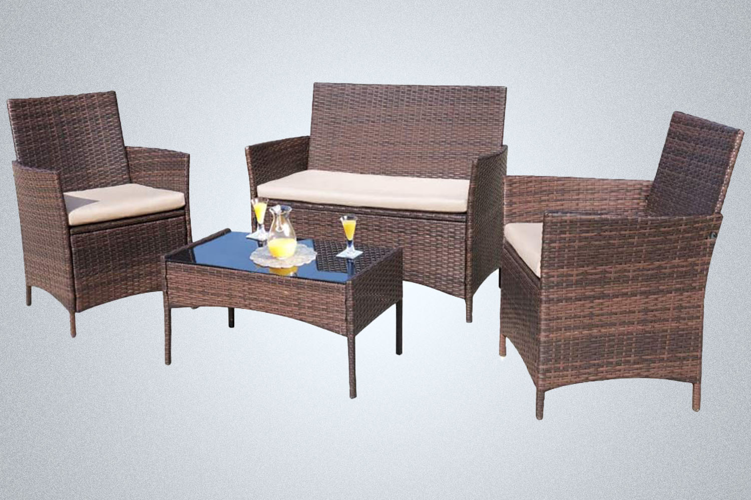 a wicker backyard patio set from Amazon on a grey background
