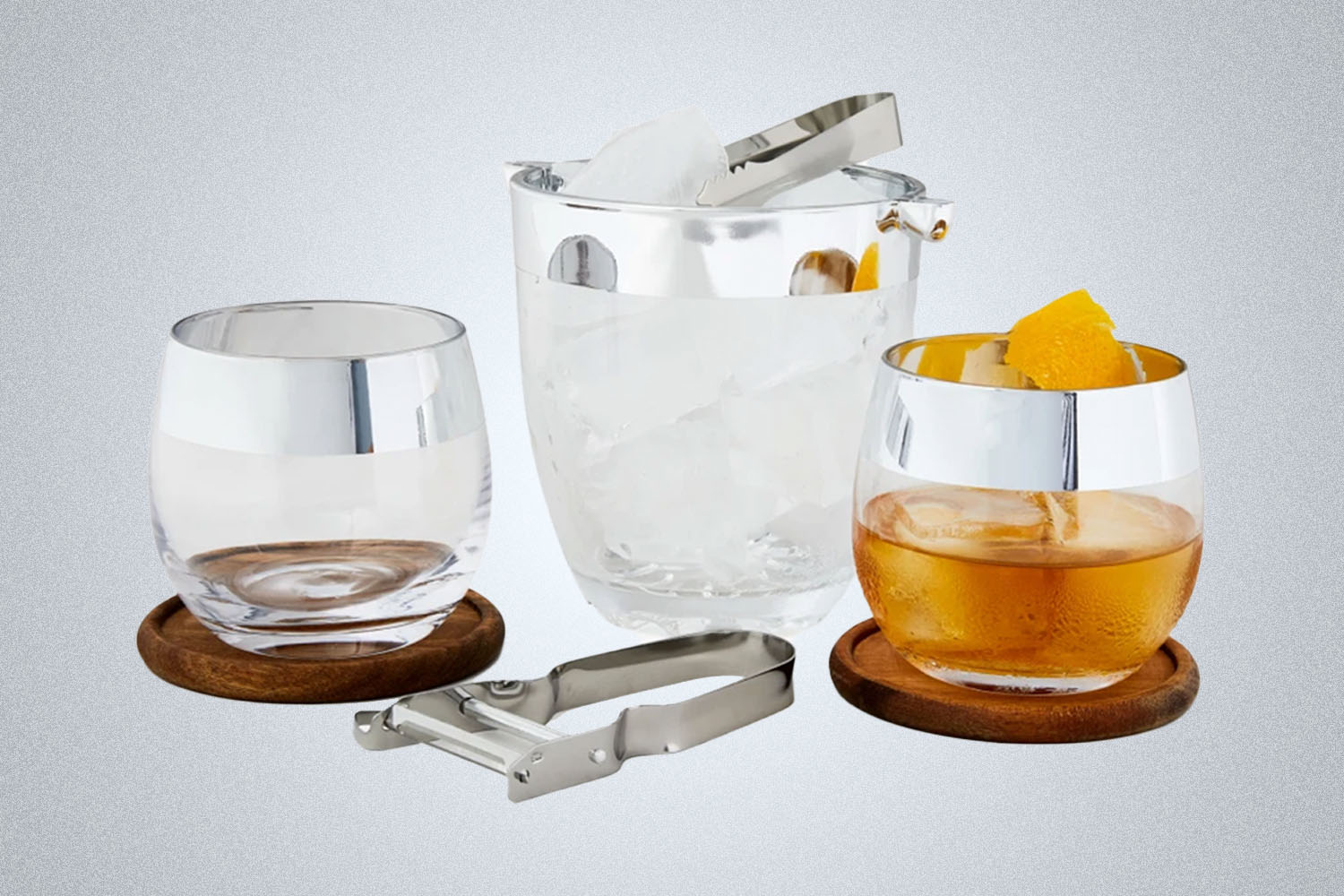 a collection of bar items from Bespoke Post on a grey background