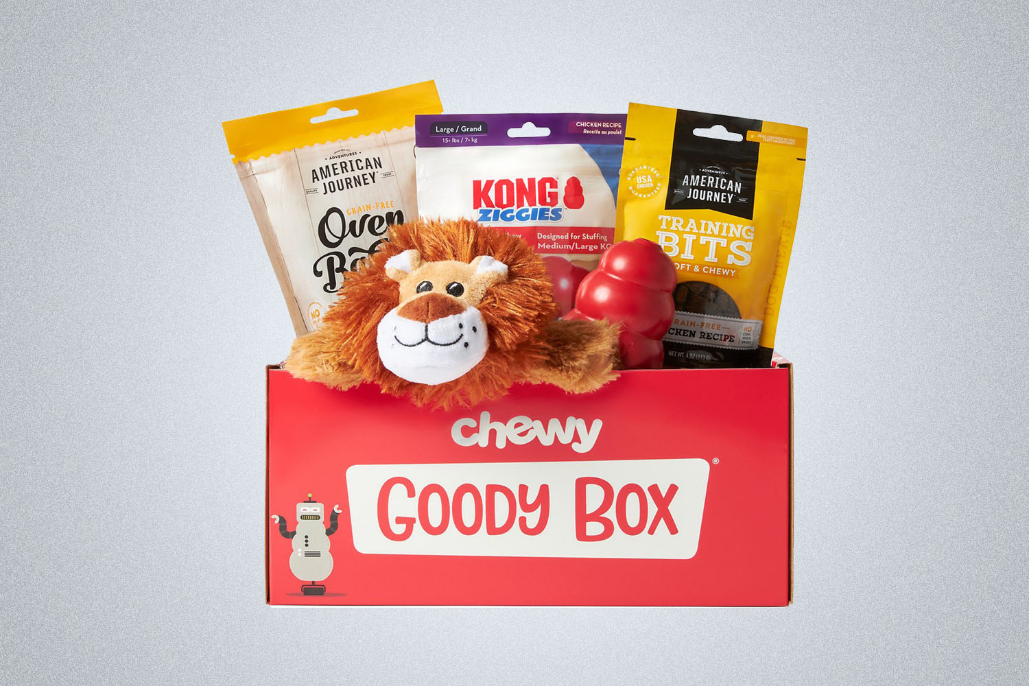 a red Chewy goody box of dog toys and treats on a grey background