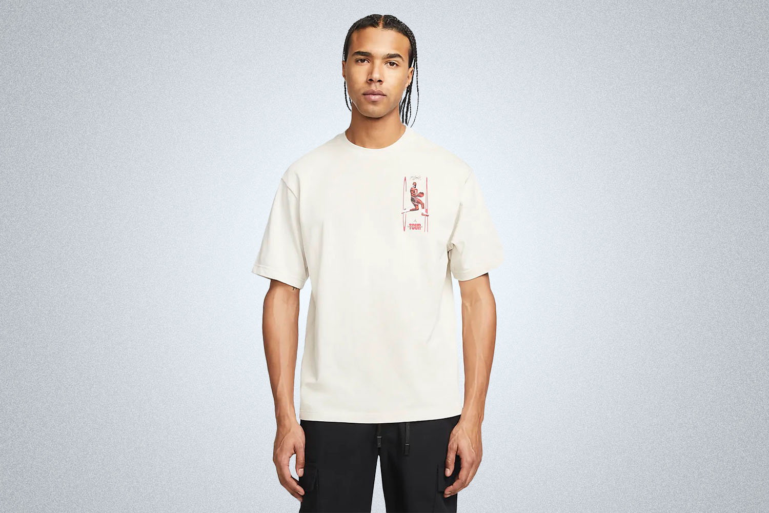 a model in a white Nike Jordan grahpic tee on a grey background