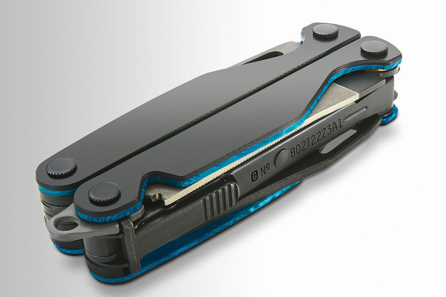 a black leatherman tool on a grey background
