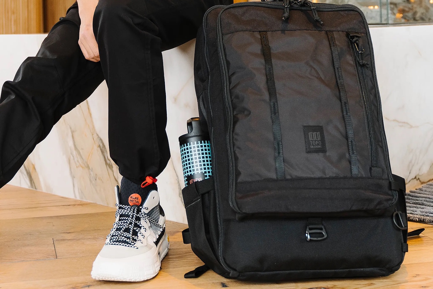 a backpack with a Topo x MiiR wattle bottle in it