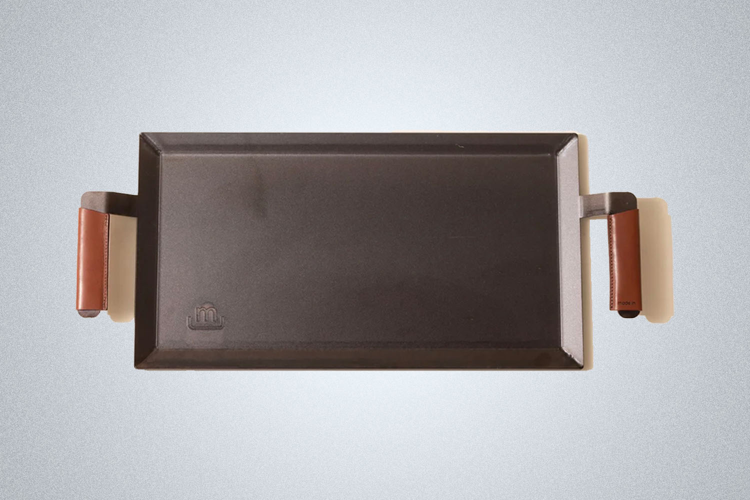 a flat iron griddle from Made In on a grey background