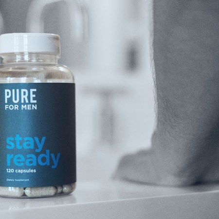 Photo shows a bottle of Pure for Men's Stay Ready Fiber supplements on a bathroom countertop