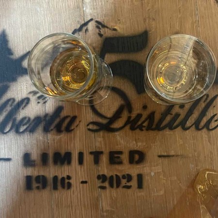 A close-up of tasting glasses on an Alberta Distillers barrel