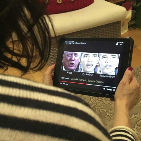 A woman in Washington, DC, views a manipulated video on January 24, 2019, that changes what is said by President Donald Trump and former president Barack Obama, illustrating how deepfake technology can deceive viewers. - "Deepfake" videos that manipulate reality are becoming more sophisticated and realistic as a result of advances in artificial intelligence, creating a potential for new kinds of misinformation with devastating consequences