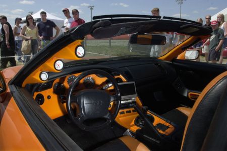 Spectators check out a 1994 Supra Toyota, an exact replica of the car featured in the movie The Fast and the Furious