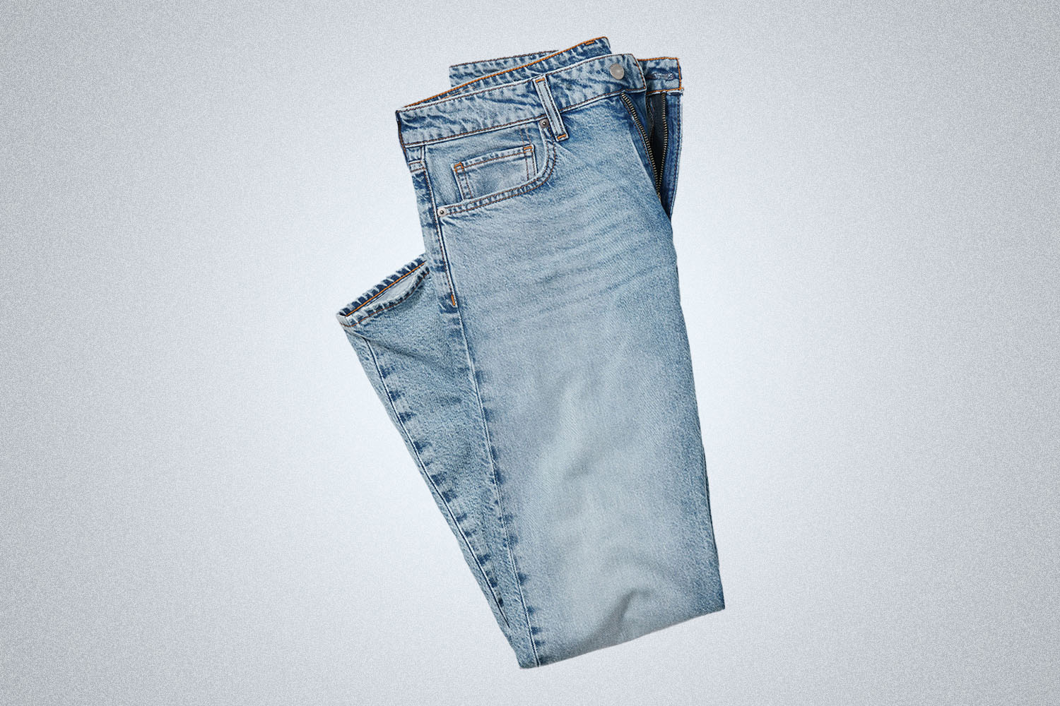 a pair of light washed folded jeans from Bonobos on a grey background