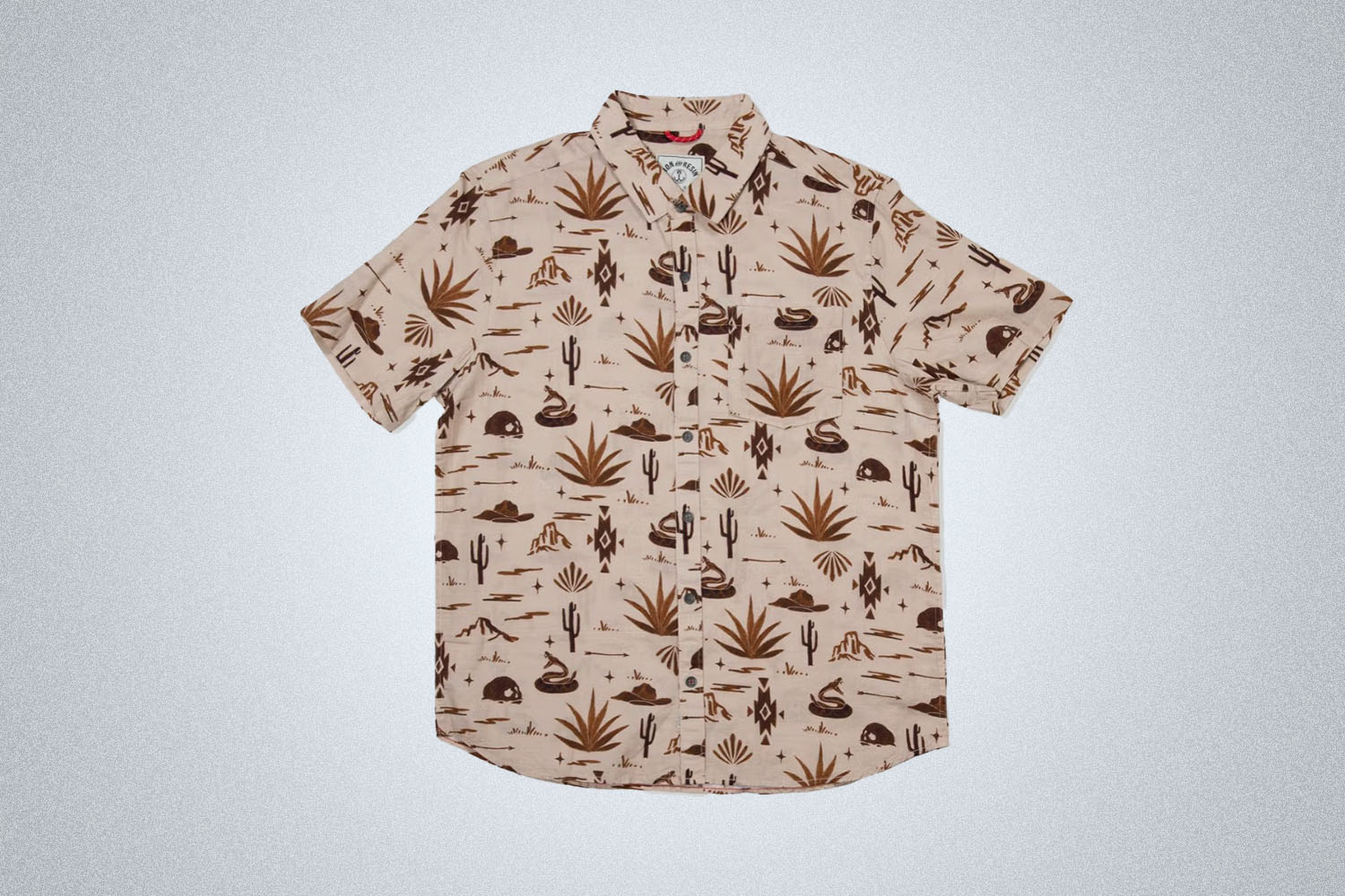 a short sleeve button up shirt with western pattern from Dust and Resin on a grey background