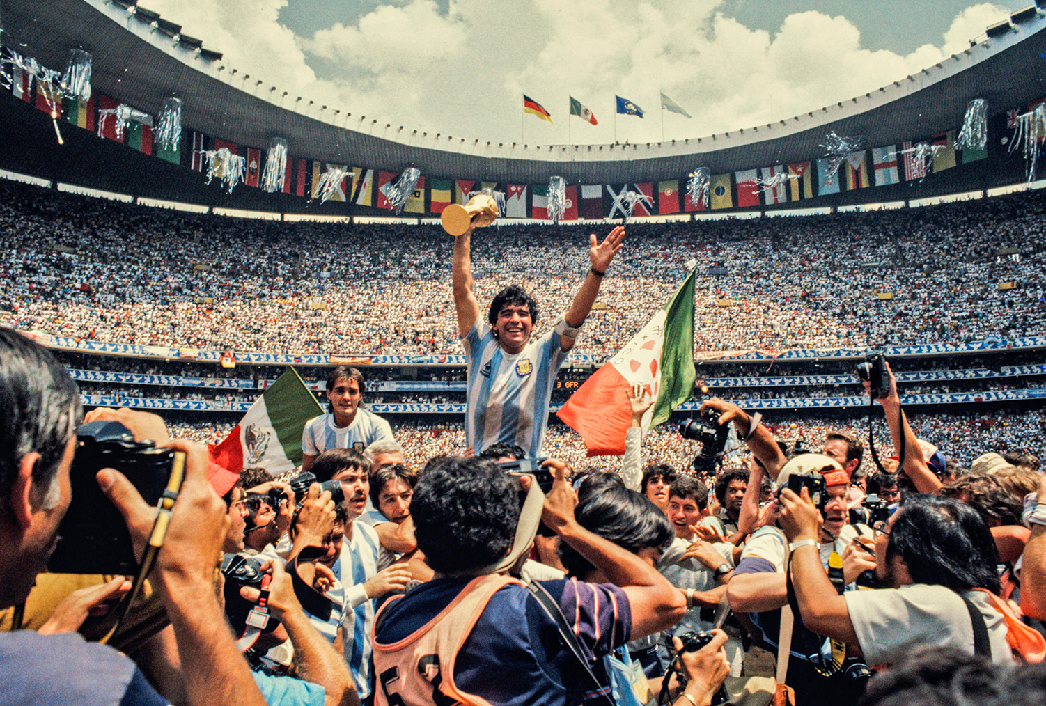 Diego Maradona holds the World Cup trophy while he is held in the air by his Argentina teammates at the 1986 tournament in Mexico