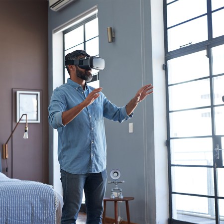 Man in hotel room with VR headset on