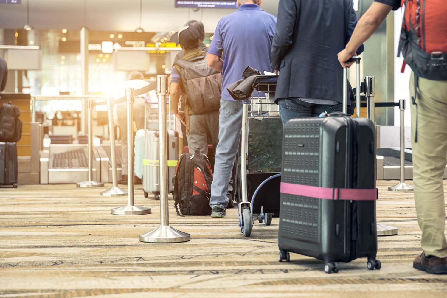 Travelers waiting in line at an airport