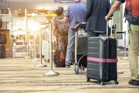 Travelers waiting in line at an airport