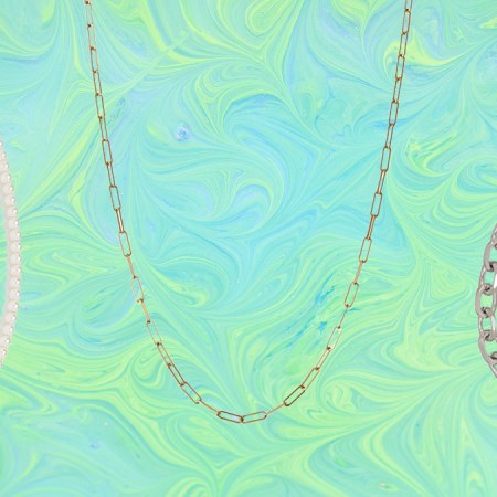 a collage of necklaces and chains on a marbled green and blue background