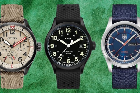 Three field watches on a green background.