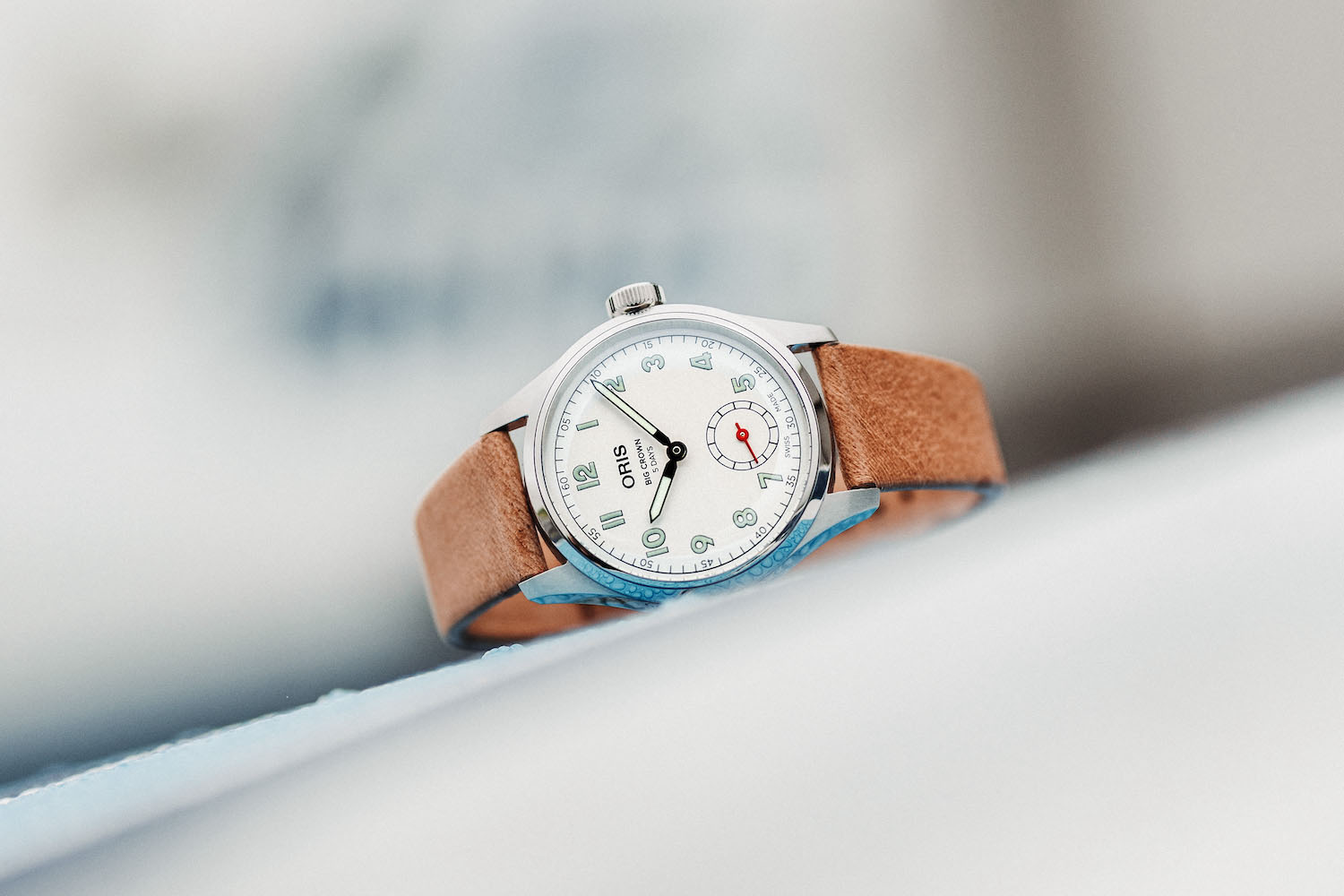 an Oris watch on its side on a table