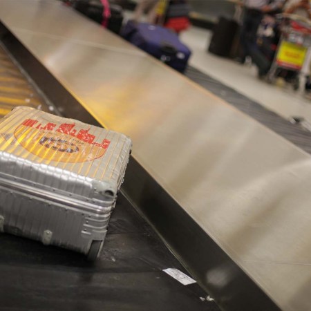 Aluminum suitcase on a baggage carousel
