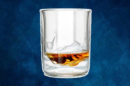 A Whiskey Peaks glass with booze in it. The glassware is on sale at Huckberry.