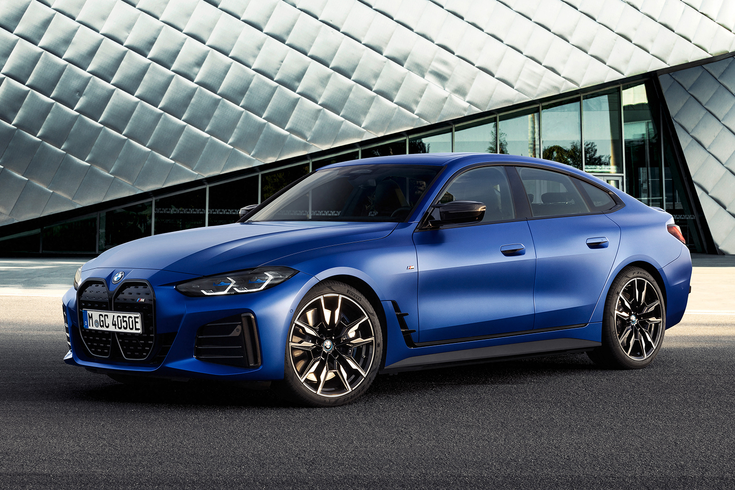 The 2022 BMW i4 M50 electric sedan parked in front of a building