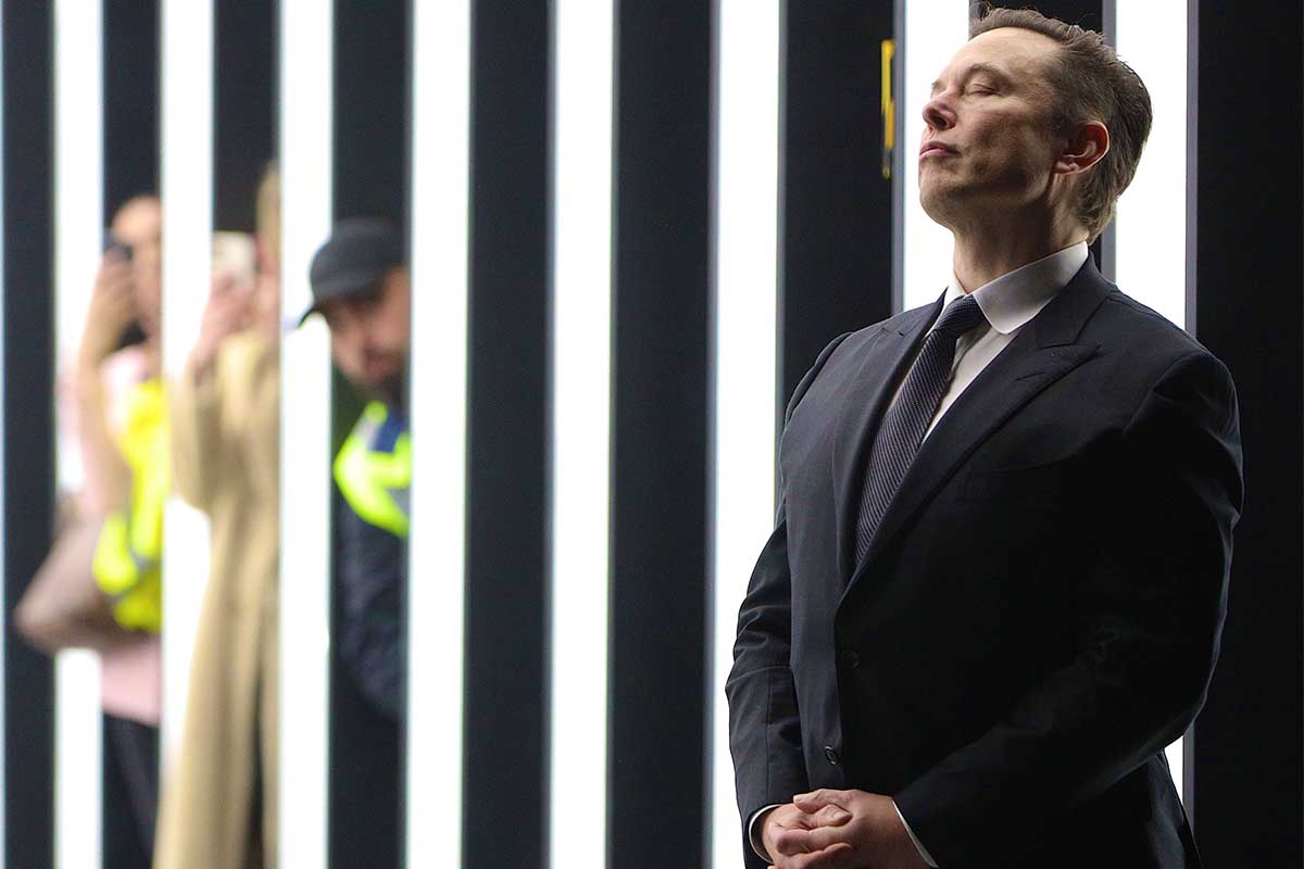 Tesla CEO Elon Musk contemplates during the official opening of the new Tesla electric car manufacturing plant on March 22, 2022 near Gruenheide, Germany. Musk has recently emphasized Tesla Optimus, a new humanoid-like robot, as his next focus.