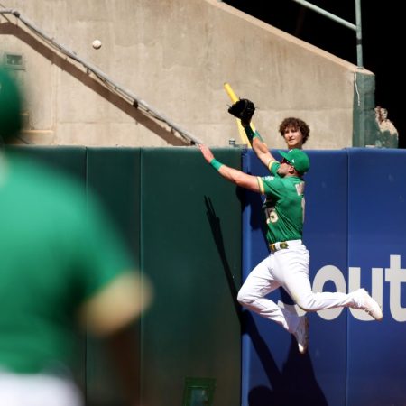 An Oakland Athletics outfielder tries to rob a home run. The A's bought land in Las Vegas and it looks like the move out of Oakland is almost done.