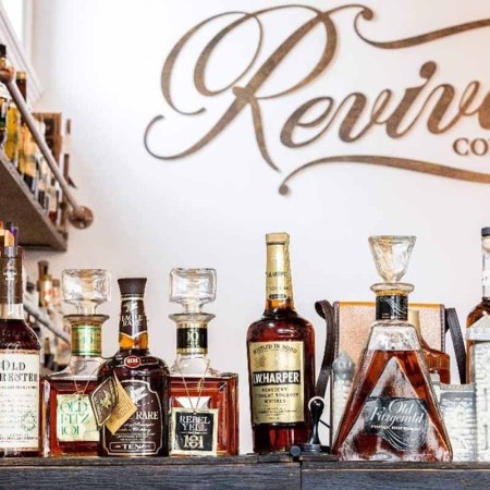 Some vintage bottles on a bar top at Covington, KY's Revival Vintage Spirits