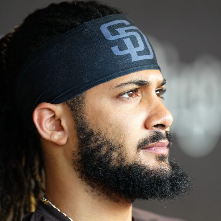 Fernando Tatis Jr. of the San Diego Padres watches warm-ups from the dugout.