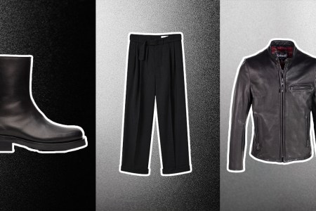 A leather jacket, black boots and black pants on a gradient black and white background