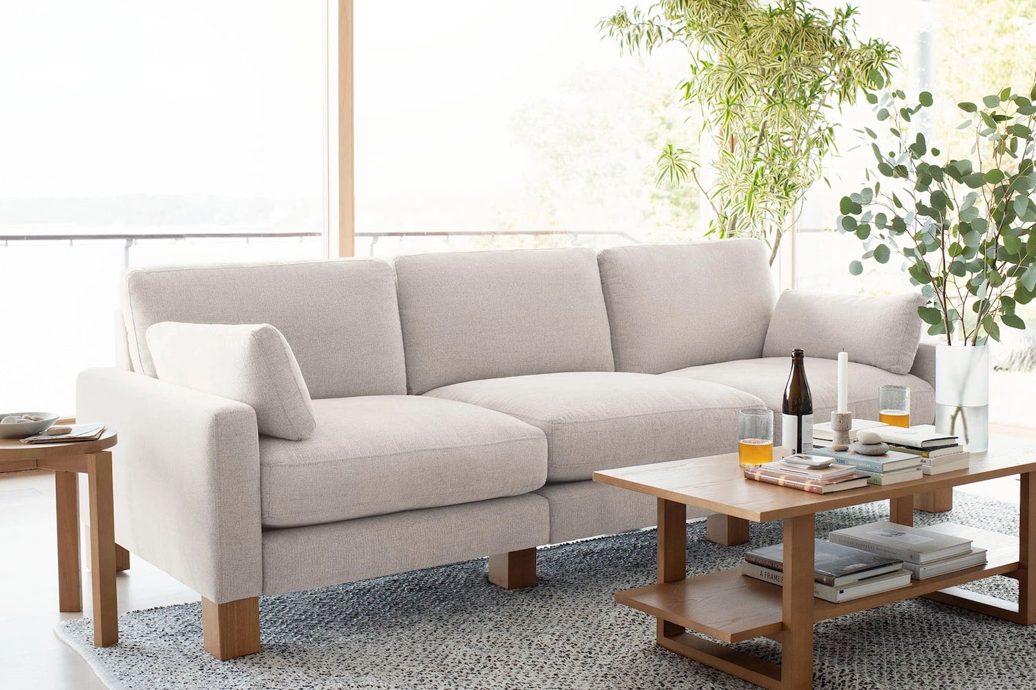 a photo of a light grey couch in a chic modern room